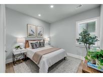 Serene bedroom featuring soft lighting, neutral decor, and a plush bed at 7631 Indigo Palms Way, Johns Island, SC 29455