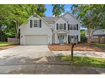 Charming two-story home with a well-manicured lawn and a two car attached garage at 800 Heyward Cove Pl, Charleston, SC 29412