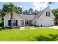 Charming single-story home with a well-manicured lawn, palm tree, and inviting front porch at 9133 Markleys Grove Blvd, Summerville, SC 29485