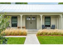 Inviting home exterior featuring a covered front porch and manicured landscaping at 922 Kincade Dr, Mount Pleasant, SC 29464