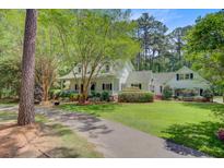 Charming two-story home with lush landscaping, a long driveway, and a welcoming front porch at 107 Kimberwicke Dr, Summerville, SC 29483