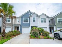 Charming townhomes featuring colorful exteriors, attached garages, and beautiful landscaping at 108 Rosefield Ct, Summerville, SC 29485