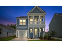Charming two-story home with a covered porch and a one car garage at 116 Midmills Ln, Summerville, SC 29486