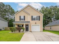 Charming two-story home with a well-manicured lawn and attached garage at 117 Ducane St, Summerville, SC 29483