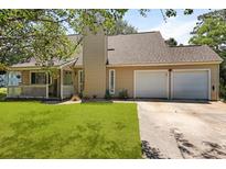 Charming home featuring a well-manicured lawn, a two car garage, and inviting front porch at 125 Crooked Creek Ct, Summerville, SC 29486
