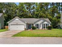 Charming single story home featuring a manicured lawn and attached two-car garage at 170 Danzid Dr, Summerville, SC 29483