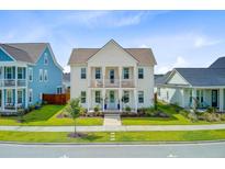 Charming two-story home featuring double porches, manicured lawn, and a welcoming blue front door at 176 Midtown Ave, Summerville, SC 29486