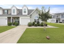 Charming townhome with a one-car garage, manicured lawn, and fresh landscaping at 192 Buchanan Cir, Goose Creek, SC 29445