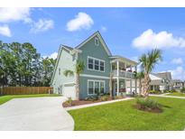 Charming two-story home with a welcoming front porch and well-manicured lawn at 1973 Parish House Cir, Johns Island, SC 29455
