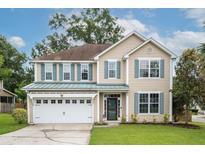 Charming two-story home featuring a well-manicured lawn, two-car garage, and inviting curb appeal at 201 Old Market Ct, Moncks Corner, SC 29461