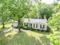 Charming single-story home featuring a well-manicured lawn and beautiful mature trees at 5 Drummond Ct, Charleston, SC 29414