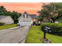 Charming one-story home featuring a two-car garage and a well-manicured front yard with lush landscaping at 5013 Franconia Dr, Summerville, SC 29485
