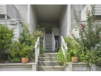 Exterior stairway leading to upper-level residences, surrounded by lush greenery at 607 Greencastle Dr, Goose Creek, SC 29445