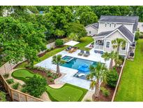 Stunning aerial view showcasing a backyard oasis with a pool, lounge area, and a unique putting green feature at 619 Thomas Glenn Ct, Charleston, SC 29412