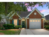 Charming single-story brick home with a well-maintained yard and attached one car garage at dusk at 9255 Ayscough Rd, Summerville, SC 29485