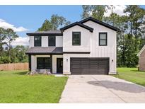 Charming two-story home with modern farmhouse design, white siding, black trim, and inviting front porch at 1000 Retreat Ave, Moncks Corner, SC 29461