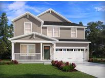 Charming two-story home featuring a covered porch, attached garage, and beautifully landscaped front yard at 101 Indigo Cove Blvd, Summerville, SC 29486