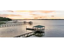 Picturesque waterfront property featuring a private dock and gazebo on calm waters at sunset at 1085 Harts Bluff Rd, Wadmalaw Island, SC 29487