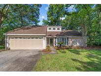 Charming single-story home featuring a two-car garage and a well-manicured lawn at 1129 Shady Grove Ln, Mount Pleasant, SC 29464