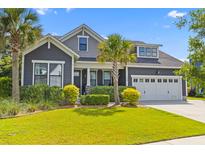 Charming gray two-story home with manicured lawn and tropical landscaping, with a convenient two-car garage at 1439 Rivers Cotton Rd, Charleston, SC 29412