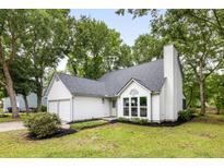 Charming home featuring a well-manicured lawn, lush trees, and a classic white exterior at 1478 Diamond Blvd, Mount Pleasant, SC 29466