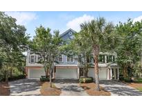 Charming townhome with manicured landscaping, garages, and welcoming curb appeal at 167 Palm Cove Way Way, Mount Pleasant, SC 29466