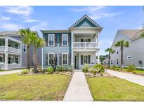 Charming two-story home with a double porch, landscaped yard, and inviting curb appeal in a vibrant neighborhood at 2219 Kemmerlin St, Johns Island, SC 29455