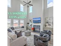 Bright living room with high ceilings, fireplace, and modern decor at 306 Lucca Dr, Summerville, SC 29486