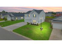 Charming two-story home featuring a manicured lawn and a well-lit street in a Gathering-friendly neighborhood at 330 Bountiful Dr, Moncks Corner, SC 29461