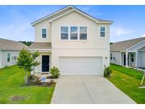 Two-story home with white siding, two-car garage, and landscaped front yard on a sunny day at 490 Pender Woods Dr, Summerville, SC 29486