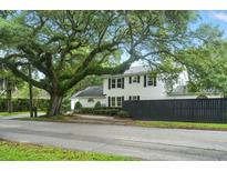 Charming two-story home with black shutters and mature tree in the front yard at 51 Stocker Dr, Charleston, SC 29407