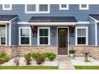 Charming townhome front door with stone accents, black awning, and manicured landscaping for welcoming curb appeal at 5133 Park Creek Ave, North Charleston, SC 29418