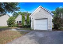 Charming single-story home with an attached garage and neat landscaping on a sunny day at 5217 Copley Cir, Summerville, SC 29485
