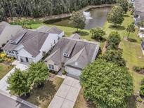 A beautiful single-Gathering home with a well-manicured lawn and a scenic pond view at 602 Eastern Isle Ave, Summerville, SC 29486