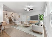 Bright living room featuring neutral tones, modern furnishings, and a staircase leading to the upper level at 705 Quintan St, Summerville, SC 29486