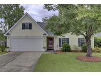 Charming single-Gathering home featuring a well-manicured lawn and a two-car garage at 104 Lancaster Ct, Goose Creek, SC 29445