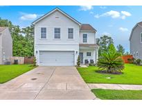 Charming two-story home with a well-manicured lawn and attached two car garage at 146 Chaste Tree Cir, Goose Creek, SC 29445