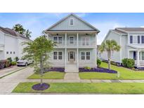 Charming two-story home with a double porch, complemented by lush landscaping and inviting curb appeal at 1485 Bourne Xing, Mount Pleasant, SC 29466