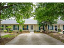 Charming townhouse featuring a well-maintained yard, quaint patio, and blue shutters at 1505 Blaze Ln, Charleston, SC 29412