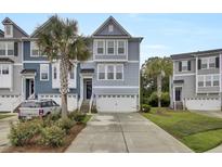 Charming townhome showcasing a blue exterior, two-car garage, and driveway at 1550 Spring Moss Rd, Mount Pleasant, SC 29466