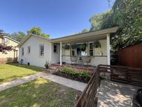 Charming front exterior featuring a cozy porch with hanging plants and well-maintained landscaping at 2309 Sunnyside Ave, Charleston, SC 29403