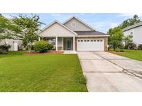 Charming single-story home featuring a well-manicured lawn, stone accents, and an attached two-car garage at 241 Clayburne Dr, Goose Creek, SC 29445