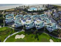 Stunning aerial view of the community with golf course, pool, and beach access at 2909 Atrium Villa, 9, Seabrook Island, SC 29455