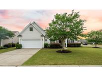 Charming single-Gathering home featuring a well-manicured lawn, attached garage, and classic white siding at 361 Waterlily Way, Summerville, SC 29486