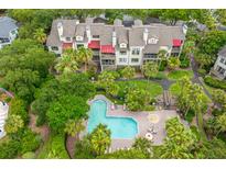 An aerial view of a building with pool and palm trees in a lush community at 408 Yacht Harbor Ct # Share 4, Isle of Palms, SC 29451