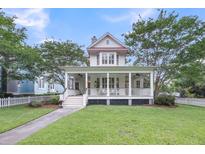Inviting two-story home with a charming wrap-around porch and manicured lawn at 701 Hibbens Grant Blvd, Mount Pleasant, SC 29464