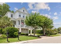 Charming two-story home featuring a welcoming front porch, well-maintained landscaping, and a convenient two-car garage at 732 Gate Post Dr, Mount Pleasant, SC 29464