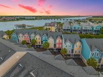 Aerial view of colorful townhomes, offering picturesque waterfront views and convenient parking at 81 Sandbar Ln # 23, Folly Beach, SC 29439