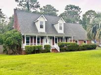 Charming home with a covered porch, dormer windows, and well-maintained landscaping at 101 Limerick Cir, Summerville, SC 29483