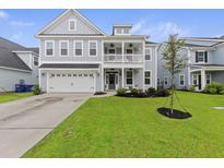 Charming two-story home with a well-manicured lawn and attached two-car garage at 1017 Saltwater Cir, Johns Island, SC 29455